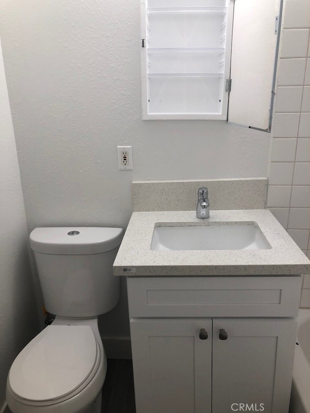 bathroom with vanity and toilet