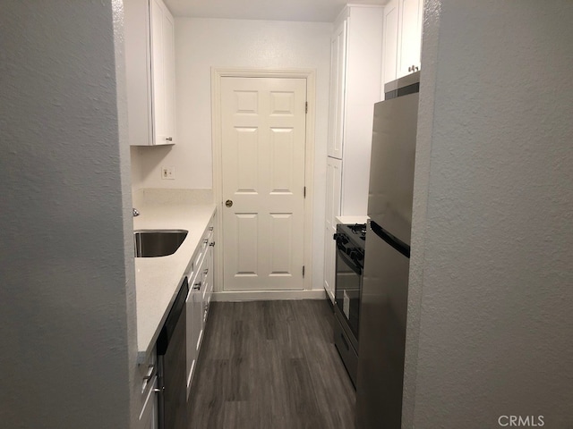 kitchen featuring sink, white cabinetry, dark wood-type flooring, and stainless steel appliances