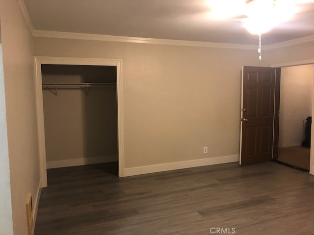 unfurnished bedroom with a closet, crown molding, and dark hardwood / wood-style flooring