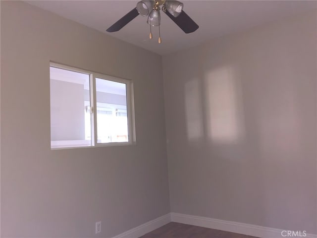 empty room with dark hardwood / wood-style floors and ceiling fan