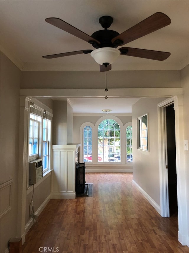 hallway featuring ornamental molding, cooling unit, and hardwood / wood-style flooring