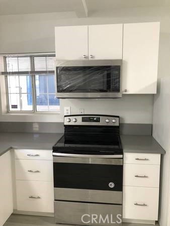 kitchen featuring appliances with stainless steel finishes and white cabinets