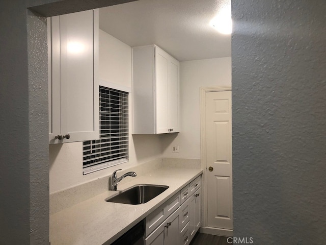 kitchen featuring sink, white cabinetry, and dark hardwood / wood-style flooring