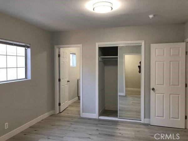 unfurnished bedroom with a closet and light hardwood / wood-style floors