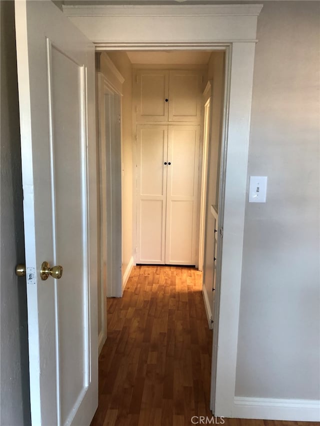 corridor with dark wood-type flooring