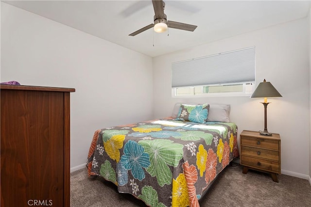 bedroom featuring ceiling fan and dark carpet