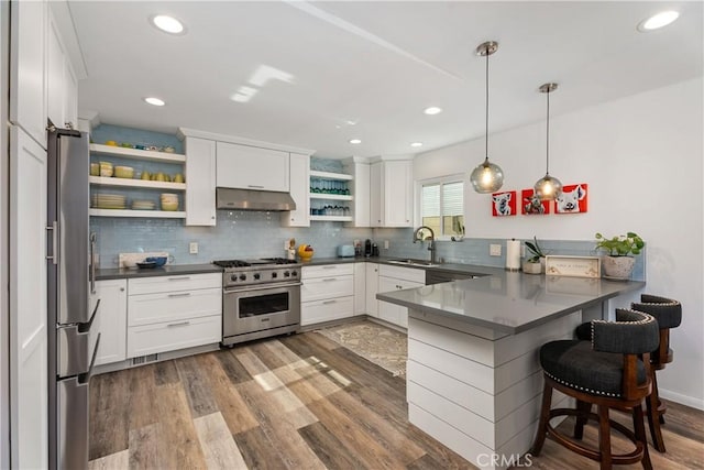 kitchen with stainless steel appliances, pendant lighting, white cabinets, and kitchen peninsula