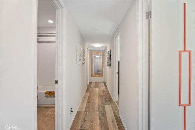 corridor with light wood-type flooring