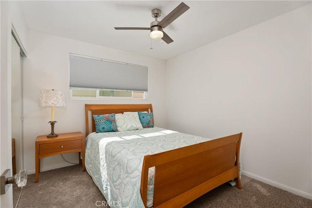 bedroom with ceiling fan, a closet, and dark colored carpet