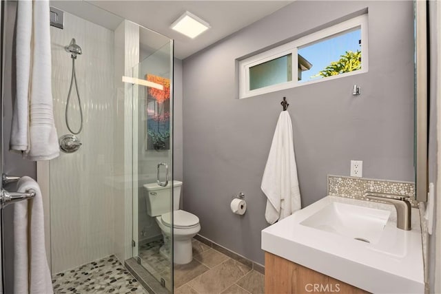 bathroom with toilet, tile patterned flooring, an enclosed shower, and vanity