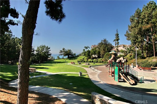 view of property's community with a playground and a lawn