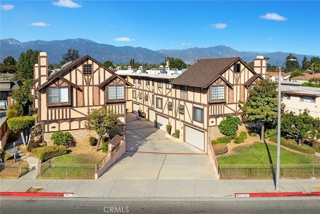 tudor house with a mountain view and a garage