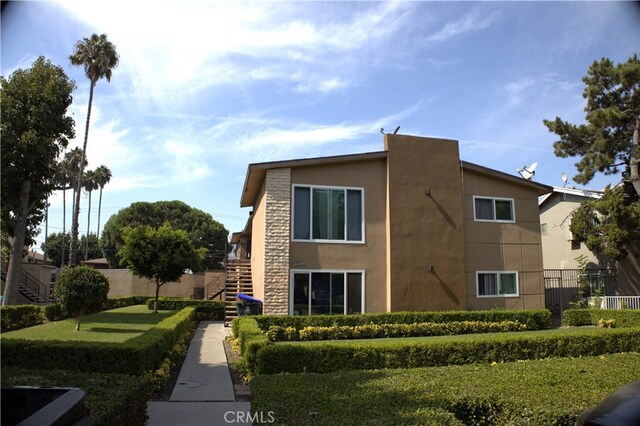 view of side of home featuring a lawn