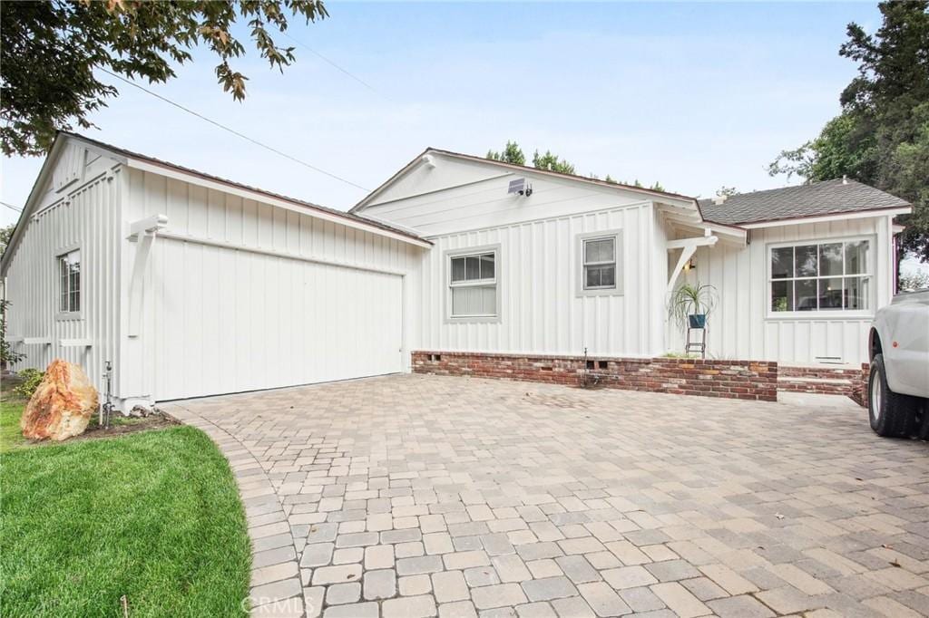 view of front of property with a front lawn and a garage