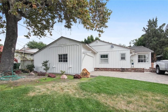 back of property featuring a lawn and a patio