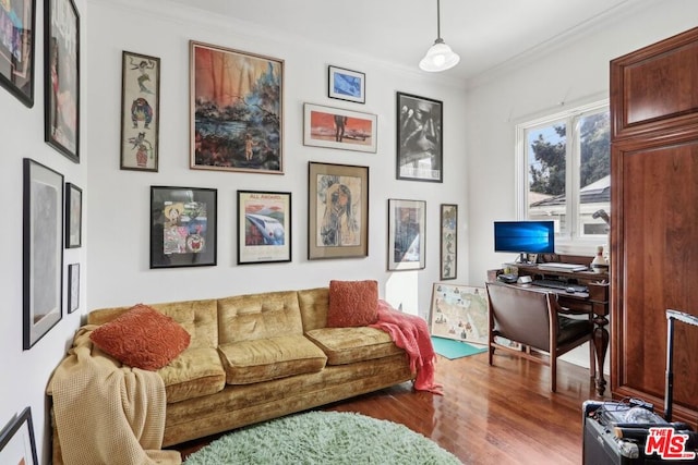 living room with hardwood / wood-style flooring and crown molding