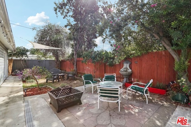 view of patio / terrace featuring a fire pit