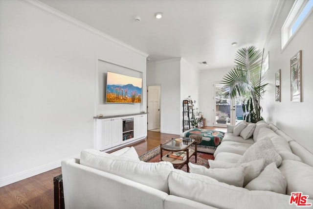 living room featuring dark hardwood / wood-style flooring and crown molding