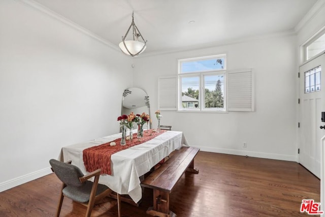 dining space with dark hardwood / wood-style flooring, crown molding, and plenty of natural light