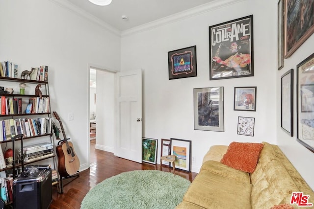 sitting room featuring dark hardwood / wood-style floors and crown molding