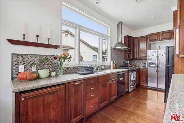 kitchen featuring tasteful backsplash, ornamental molding, wall chimney exhaust hood, stainless steel appliances, and dark hardwood / wood-style floors