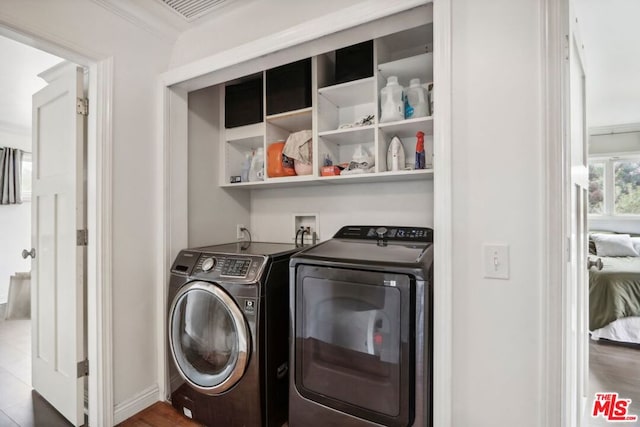 clothes washing area featuring ornamental molding and independent washer and dryer