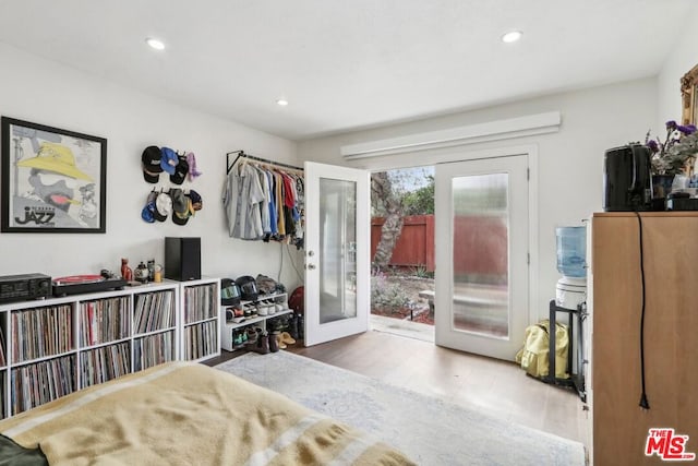 bedroom featuring access to exterior, french doors, and hardwood / wood-style flooring