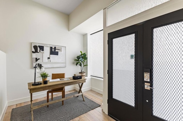 office area featuring light hardwood / wood-style flooring and french doors