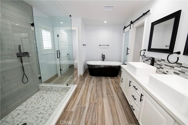 27404 Outrigger Ln, Helendale, CA 92342 - full bath featuring a shower stall, a freestanding tub, double vanity, decorative backsplash, and recessed lighting