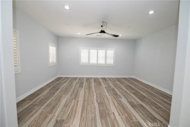 spare room featuring hardwood / wood-style floors and ceiling fan