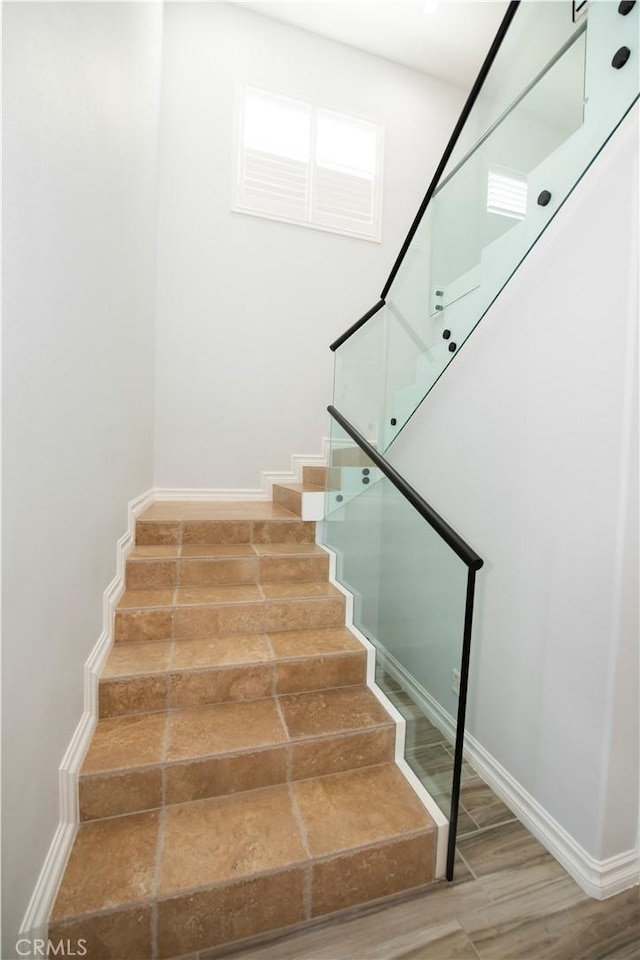 stairway with hardwood / wood-style floors