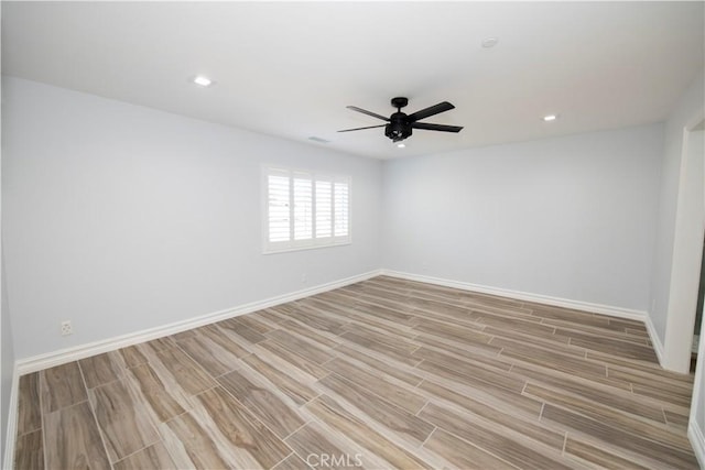 unfurnished room with ceiling fan and light wood-type flooring