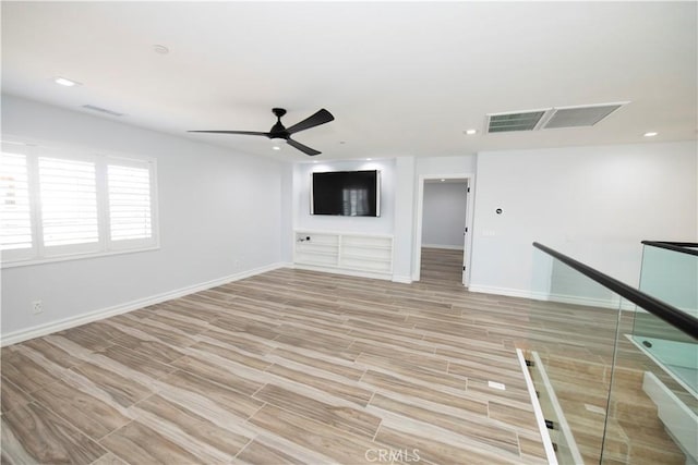 unfurnished living room featuring light hardwood / wood-style floors and ceiling fan