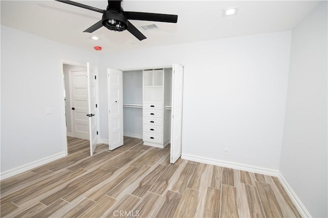 unfurnished bedroom with ceiling fan, a closet, and light hardwood / wood-style floors