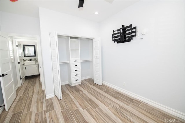 unfurnished bedroom with light wood-type flooring, a closet, and ceiling fan