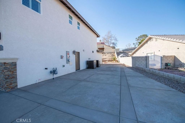 27404 Outrigger Ln, Helendale, CA 92342 - view of home's exterior with stucco siding, fence, a patio area, and cooling unit