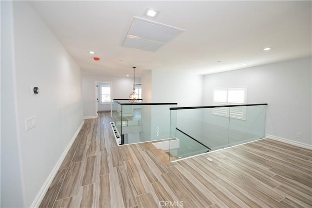 hall with plenty of natural light and light hardwood / wood-style floors