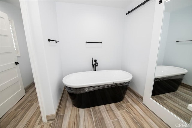 bathroom featuring hardwood / wood-style flooring and a bathing tub