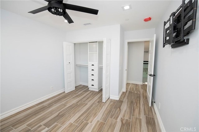 unfurnished bedroom with ceiling fan, light hardwood / wood-style floors, and a closet