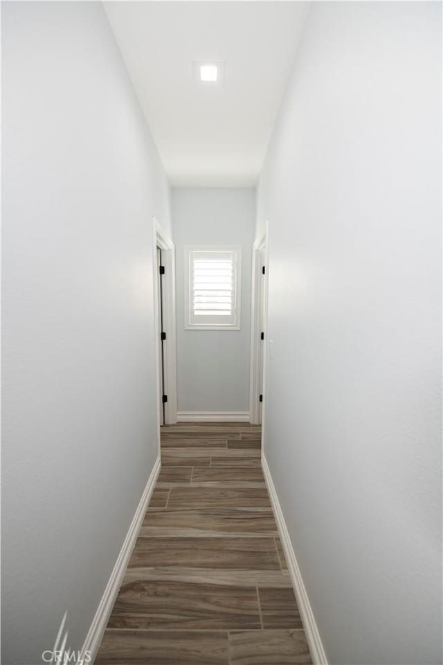 hallway with dark hardwood / wood-style floors