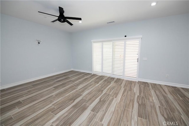 unfurnished room with light wood-type flooring and ceiling fan