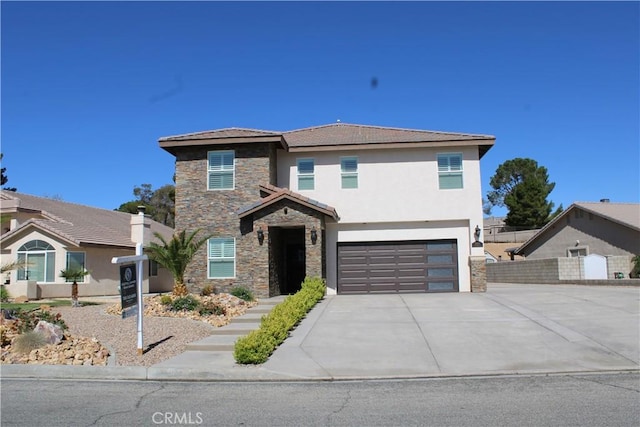 27404 Outrigger Ln, Helendale, CA 92342 - view of front facade with stone siding, concrete driveway, a garage, and stucco siding