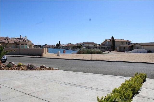 27404 Outrigger Ln, Helendale, CA 92342 - view of concrete road with a residential view, sidewalks, and curbs