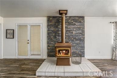 living room with dark hardwood / wood-style flooring and a wood stove