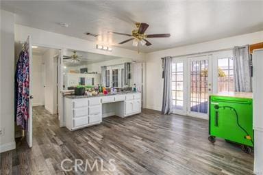 kitchen featuring ceiling fan, dark hardwood / wood-style flooring, and white cabinetry