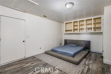 bedroom featuring dark hardwood / wood-style flooring