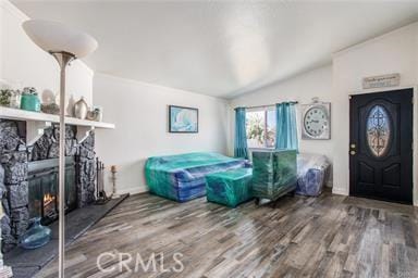 foyer entrance with hardwood / wood-style flooring and vaulted ceiling