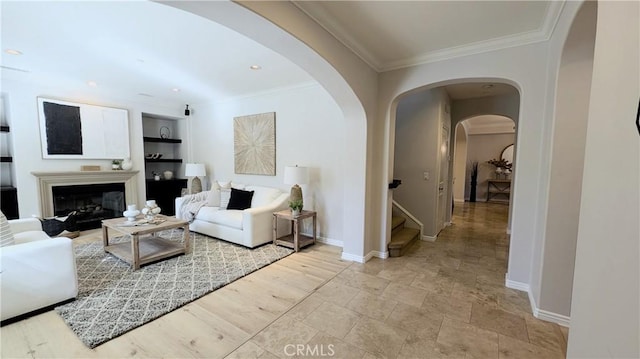 living room featuring built in features and crown molding