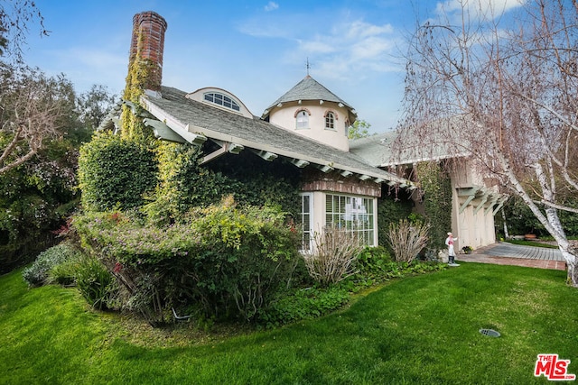 view of side of home featuring a lawn