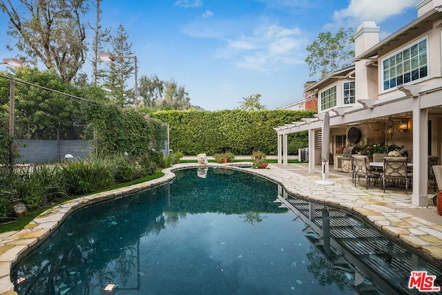 view of pool featuring a pergola and a patio area